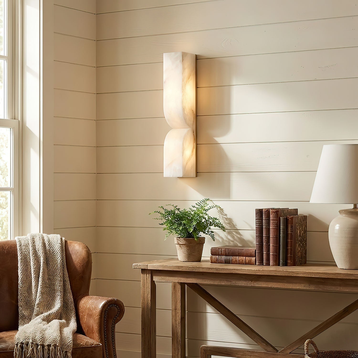 Sculptural alabaster wall light showing curved carved stone detail