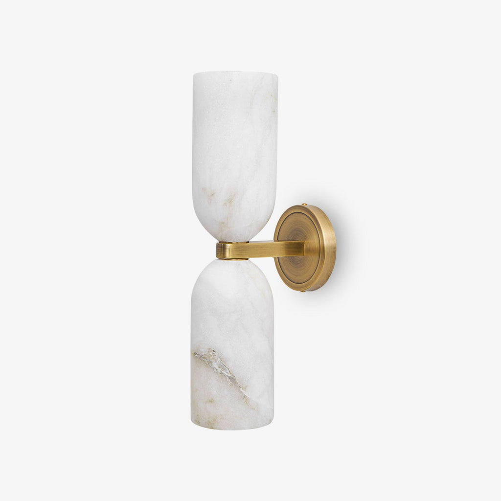 Symmetrical alabaster sconce with bronze nexus on an interior wall