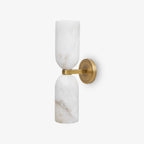 Symmetrical alabaster sconce with bronze nexus on an interior wall