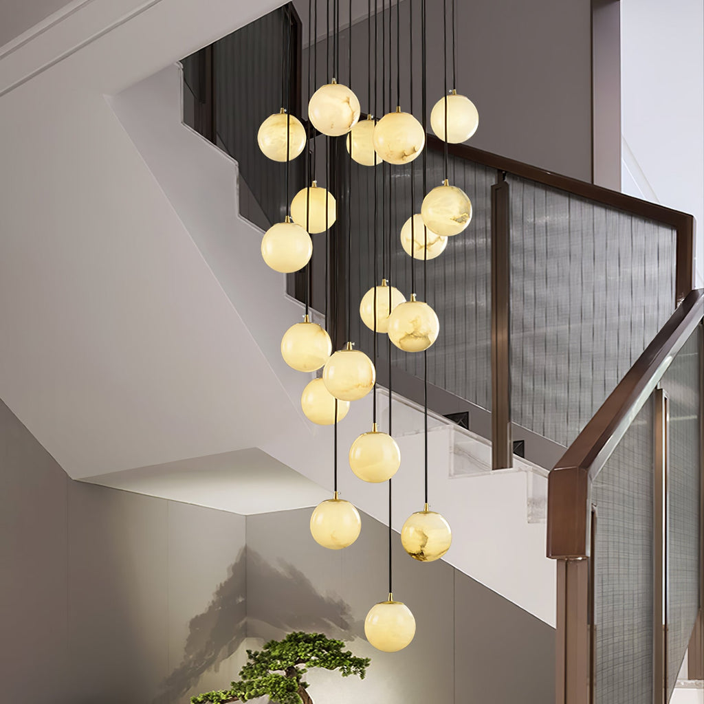 The cluster in a stairwell seen from the landing, its lowest ball just above a bonsai.