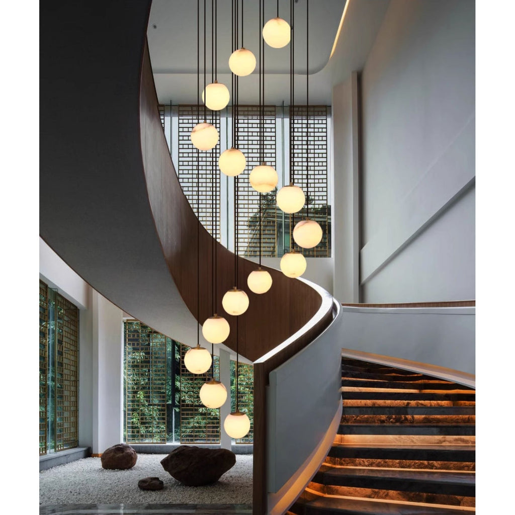 The cluster dropping through a walnut spiral staircase above a gravel and stone garden.