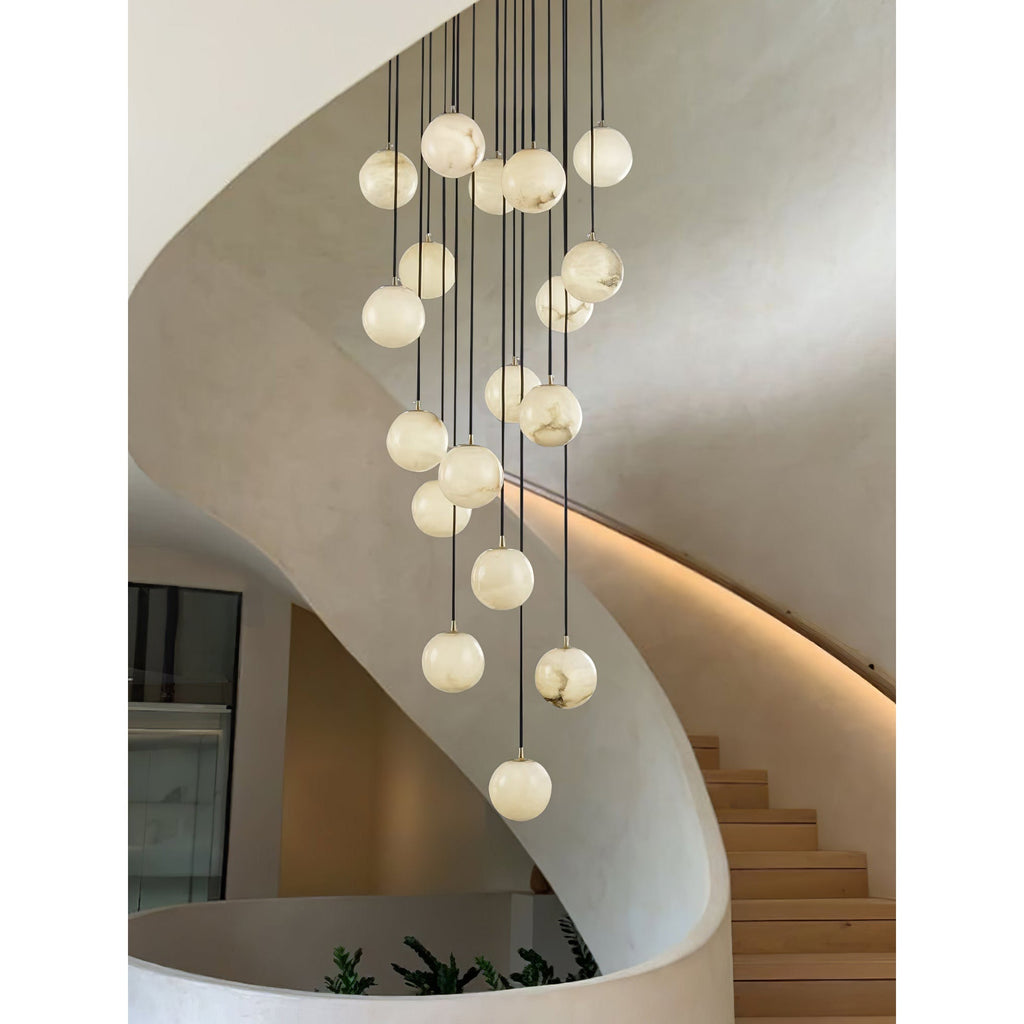 Alabaster balls cascading down a sculpted plaster stairwell, with planting at the foot.
