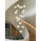 Alabaster balls cascading down a sculpted plaster stairwell, with planting at the foot.