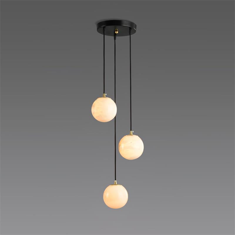 The three-ball Afralia alabaster chandelier, its spheres staggered down black cords on grey.
