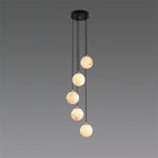 The five-ball Afralia alabaster chandelier, spheres stepping down in a loose spiral.