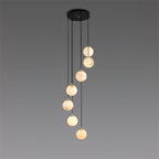 Seven alabaster balls of the Afralia chandelier, each on its own black cord and brass cap.