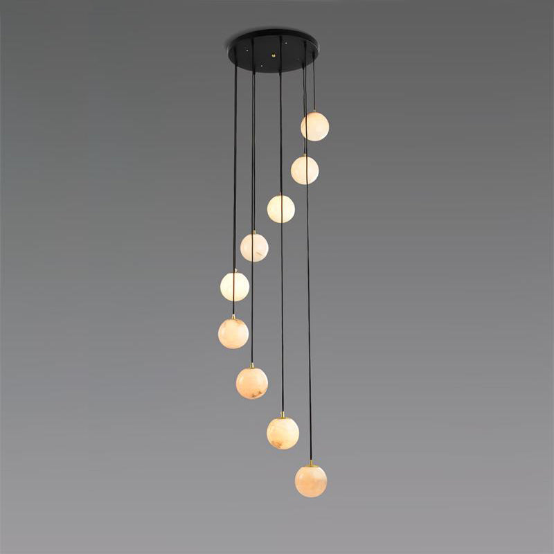 The nine-ball Afralia chandelier spiralling down from its round black ceiling plate.