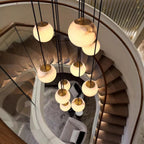 Looking down the cluster from above a spiral staircase, brass caps and the room below in view.