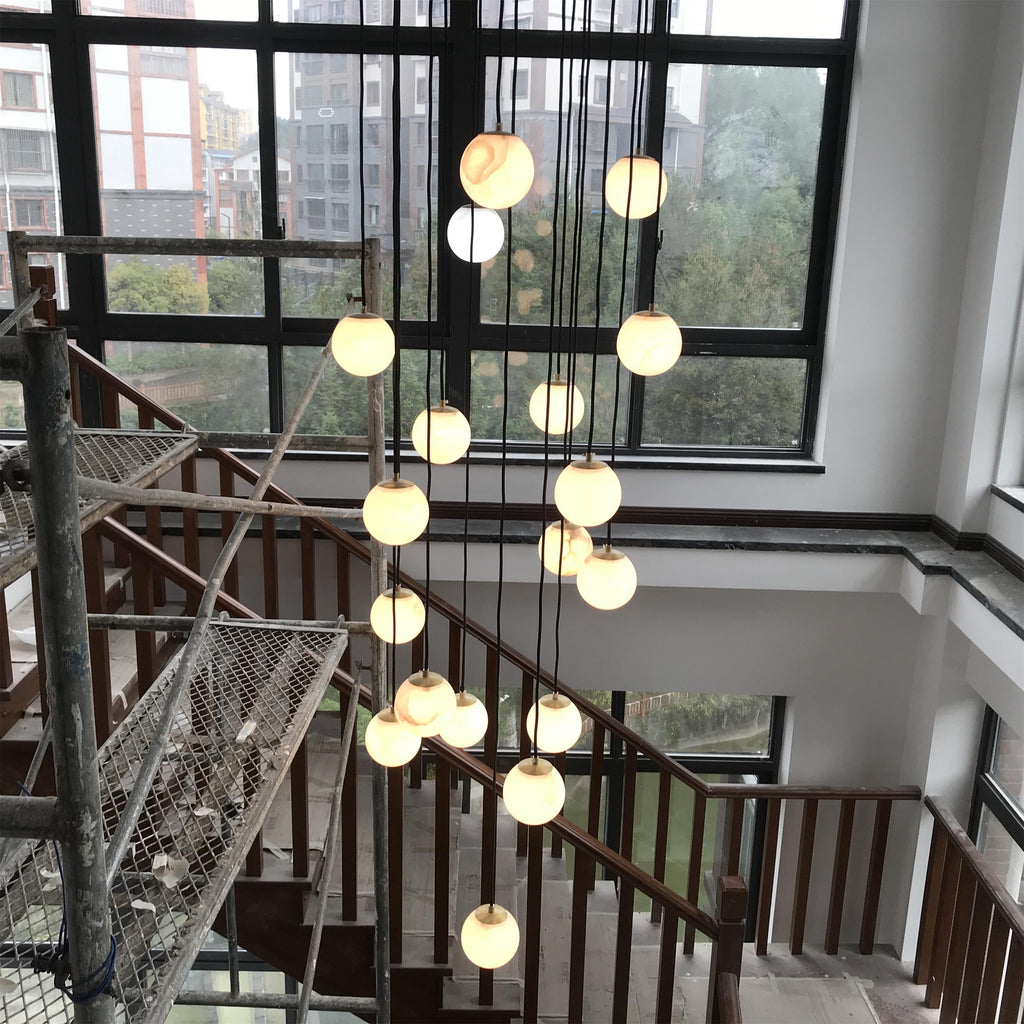 The cluster installed in a double-height stairwell, photographed during the fit-out.