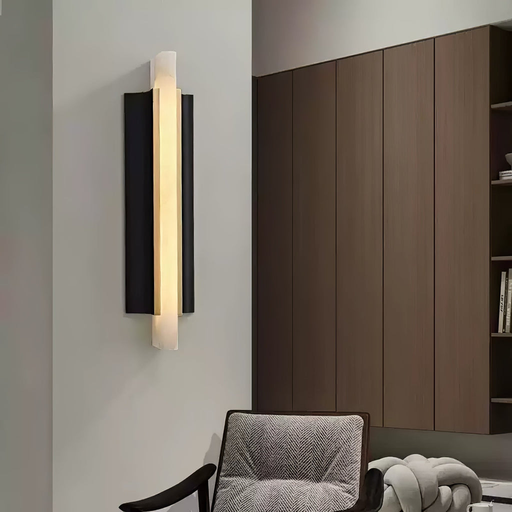 Lit on a pale wall in a living room, tall walnut cabinetry filling the right of the frame.