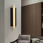 Lit on a pale wall in a living room, tall walnut cabinetry filling the right of the frame.