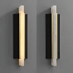 The fixture shown lit and unlit side by side on grey, comparing glow with raw stone.