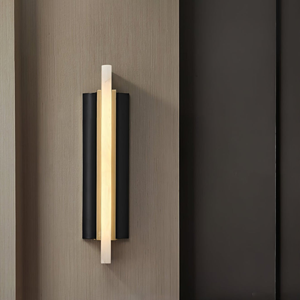 Side-angle view of the Aurelian sconce on wood panelling, showing the brass channel behind the stone blade