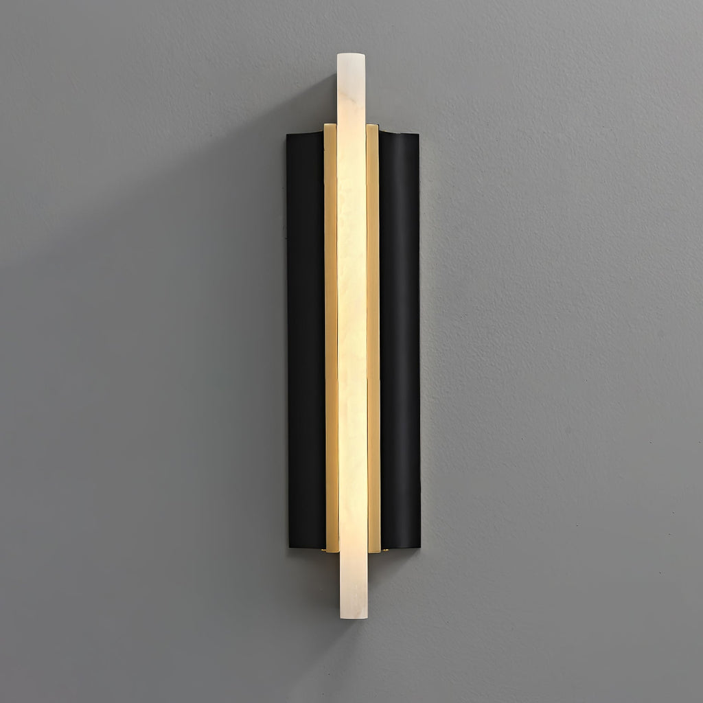 Blade wall light on a grey wall, a lit alabaster strip crossing a black metal backplate.