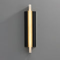 Blade wall light on a grey wall, a lit alabaster strip crossing a black metal backplate.