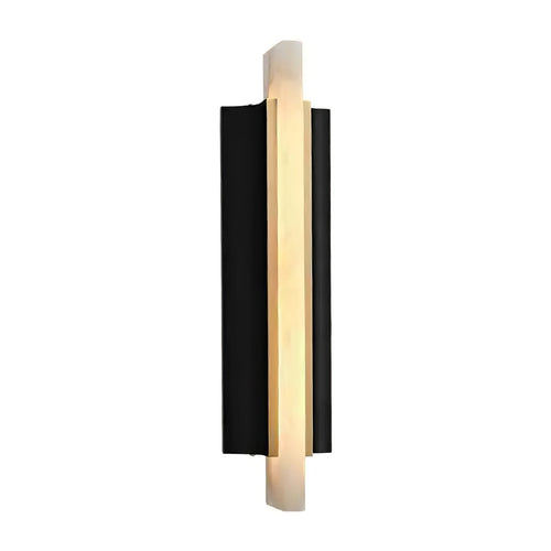 Three-quarter studio view of the lit Aurelian alabaster sconce on white, brass edge catching the light