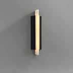 The light on grey seen straight on, alabaster blade centred on the black panel.