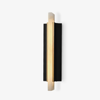 Studio view on white showing the alabaster blade overlapping the black curved backplate.