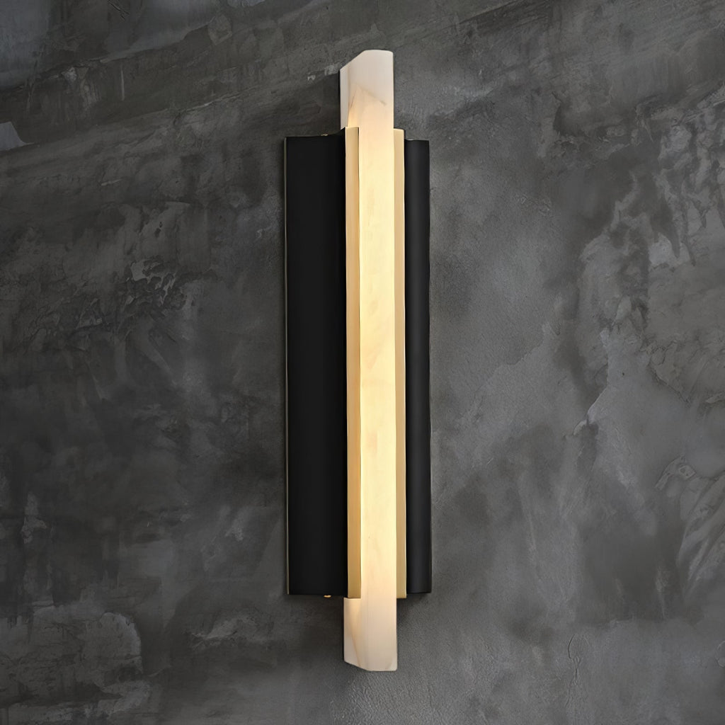The light lit against a textured concrete wall, its alabaster blade glowing warm.
