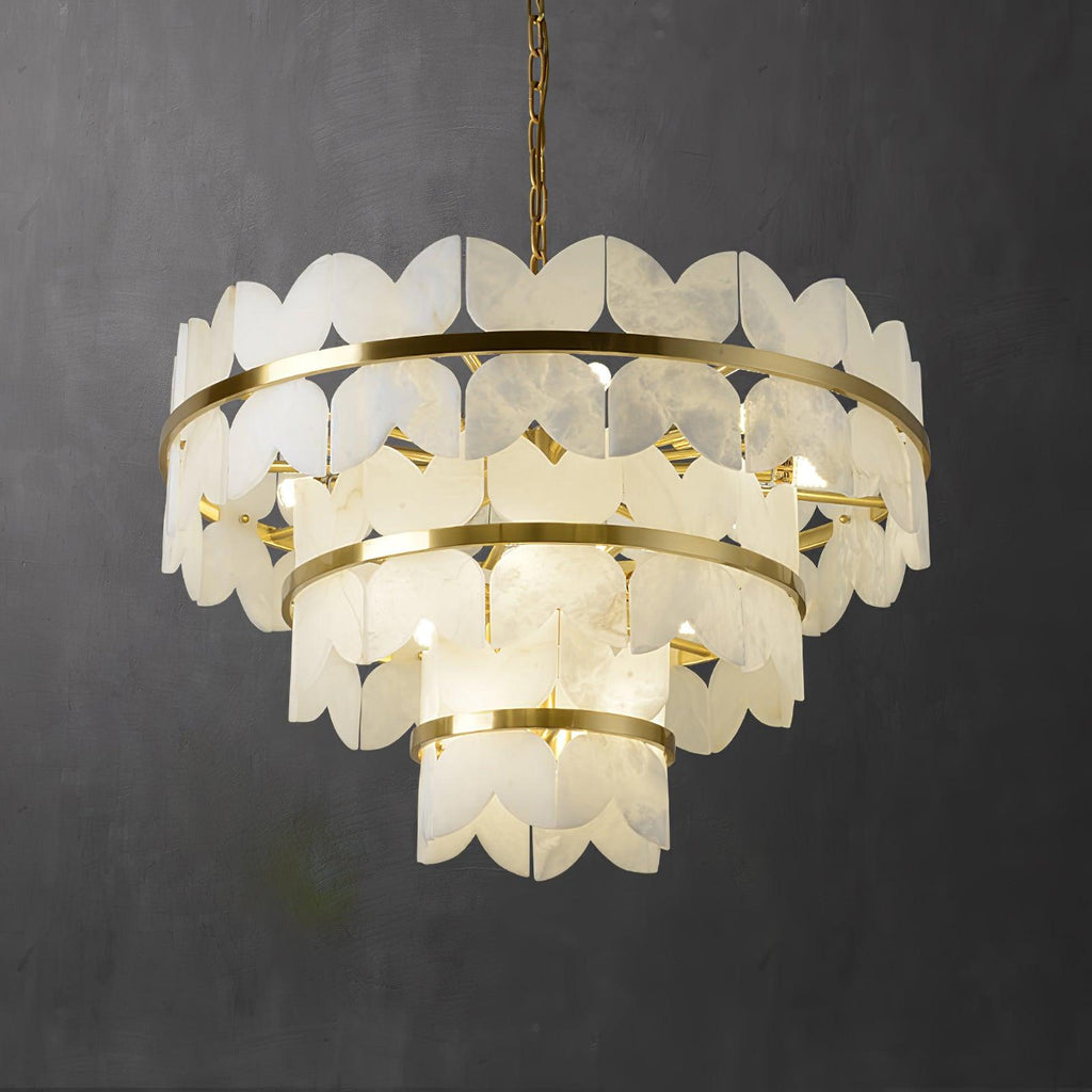 The three-tier version lit on dark grey, light escaping between the scalloped panels.