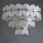 Three tiers on grey, viewed slightly from below so the lamps inside are visible.