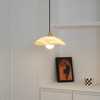 Nerea pendant lit in the alcove, the glow catching the cloudy veining across the shade.