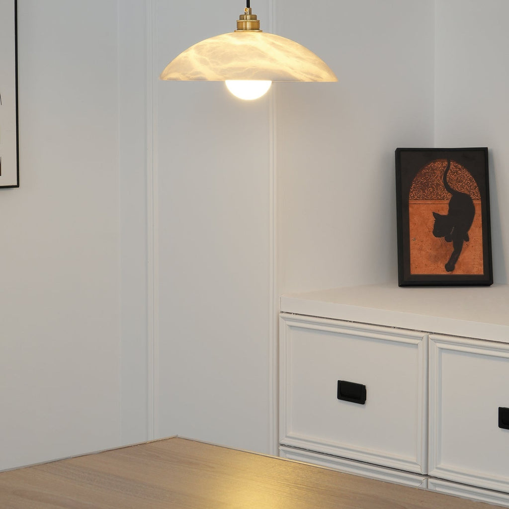 Nerea pendant switched on in the same white alcove, warm light spilling onto the wooden floor.