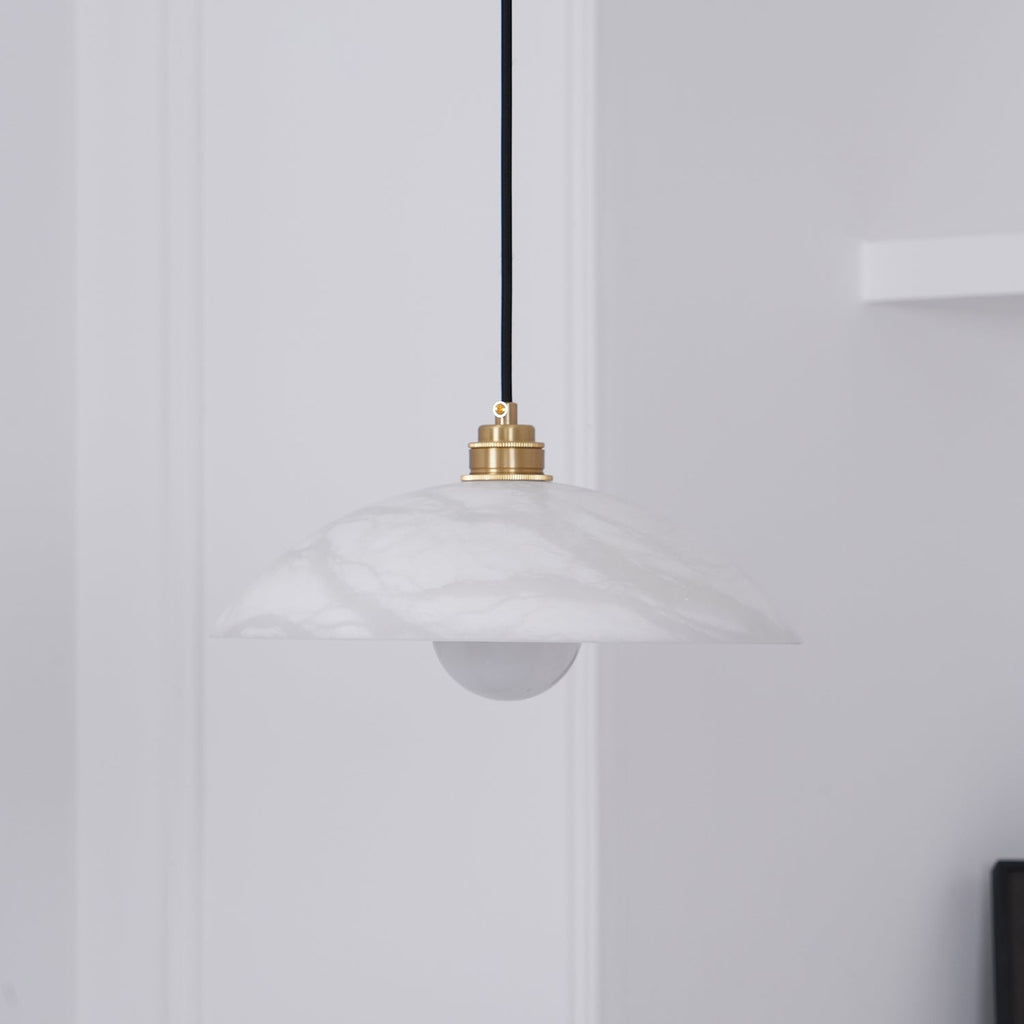 Close view of the unlit Nerea shade from below, its frosted bulb visible under the stone rim.
