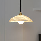 Alabaster dome pendant light with brass fitting and warm glow