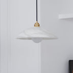 Genuine alabaster dome pendant glowing warmly over a table