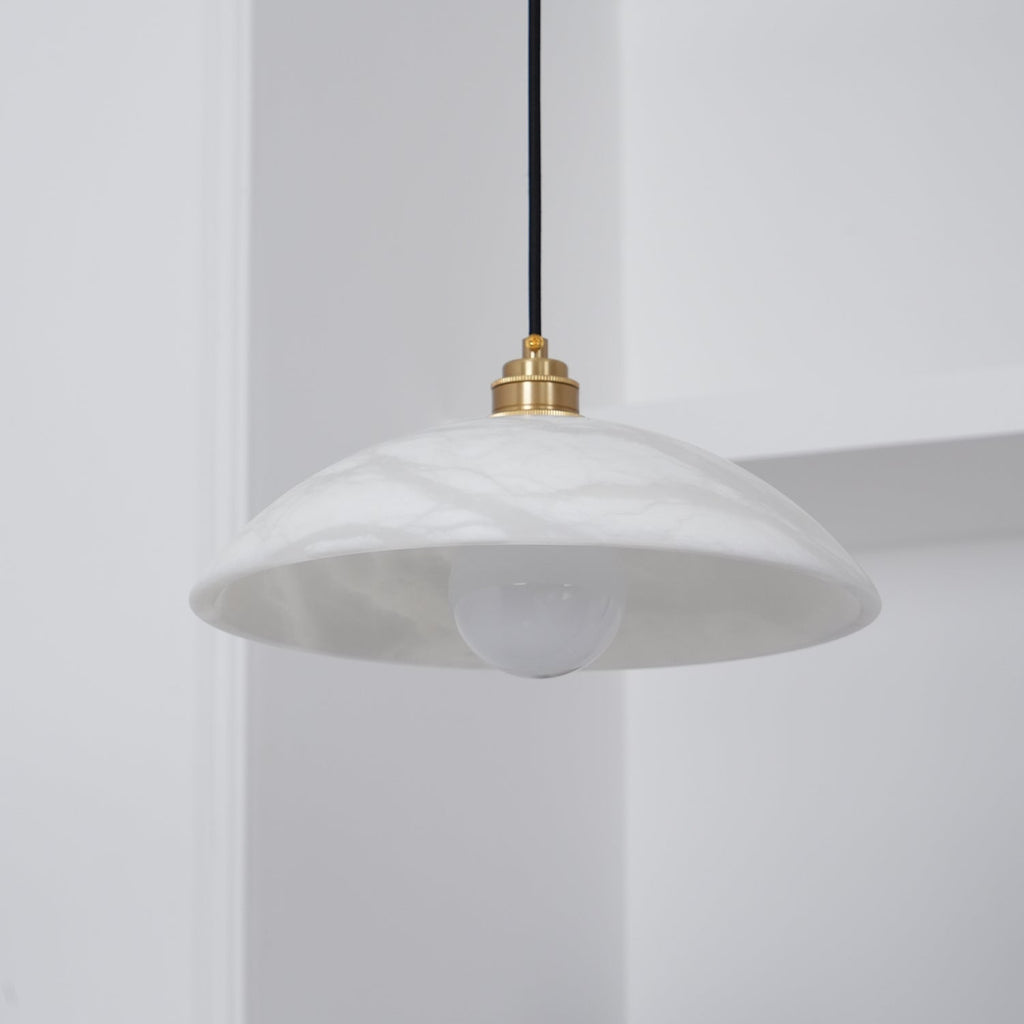 Angled unlit view into the Ritta pendant's dome, showing the smooth interior and globe bulb.