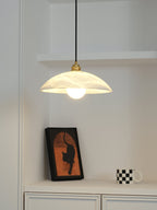 White alabaster pendant casting a soft warm mineral glow