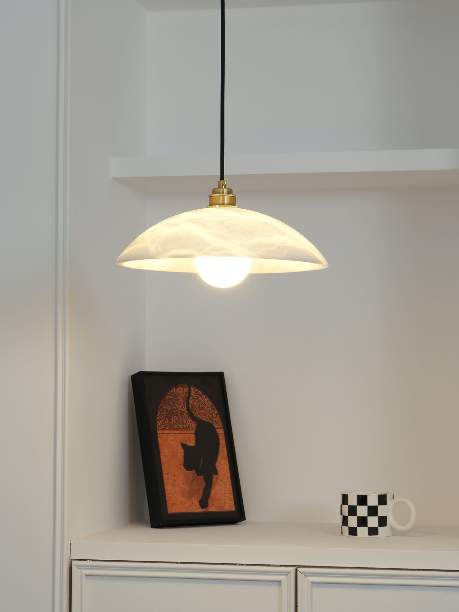 White alabaster pendant casting a soft warm mineral glow