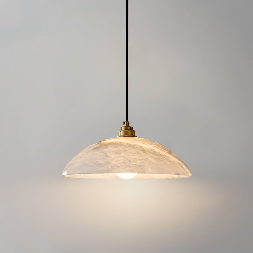 Alabaster dome pendant light glowing warmly in a styled interior