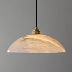 Brass and alabaster dome pendant casting a warm inviting glow
