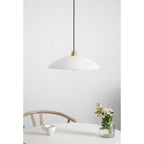 Unlit Nerea pendant seen closer above a dining chair, the alabaster almost white in daylight.