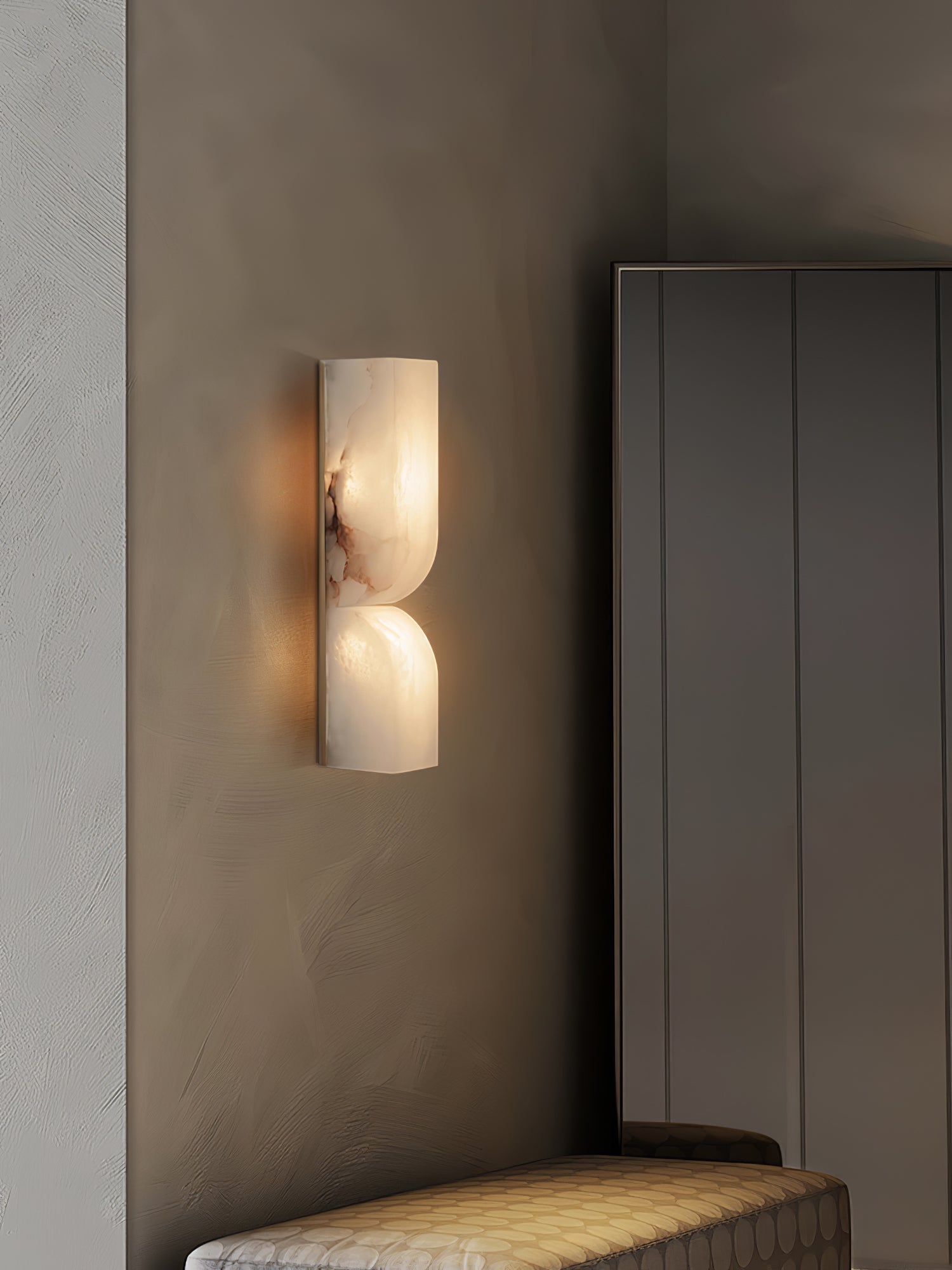 White alabaster wall light glowing softly with natural veining