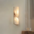 Sculptural alabaster sconce showing curved carved stone and glow