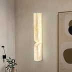 Carved alabaster wall light with warm ambient glow in a room