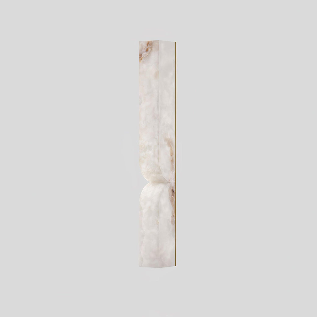 Alabaster essence wall sconce casting a warm sculptural glow