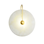 Cut-out product image of the lit gold Elaris wall light on a plain white background.