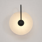 Straight-on view of the black Elaris wall light, the round mount disc sitting at the arm's end.