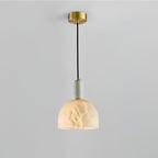 Clérachic alabaster pendant light on a plain light-grey background, another full studio view of the lit dome shade.