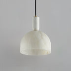 Clérachic alabaster pendant light on a grey backdrop, shown close enough to see the full cord length and canopy detail.