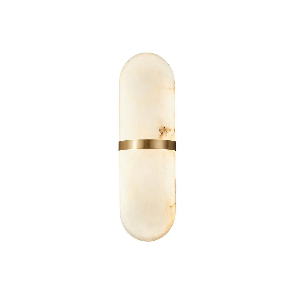 Clérachic ostruvyd alabaster wall lamp with brass band on a plain white background, softly lit from within