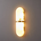 Clérachic side-angle view of the lit lamp, showing how the alabaster shade stands off the wall