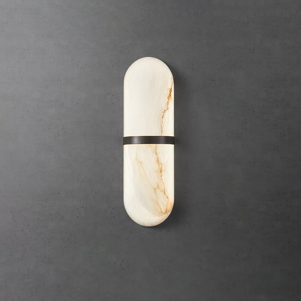 Clérachic slim alabaster wall lamp with a dark bronze band, softly lit on a textured concrete wall