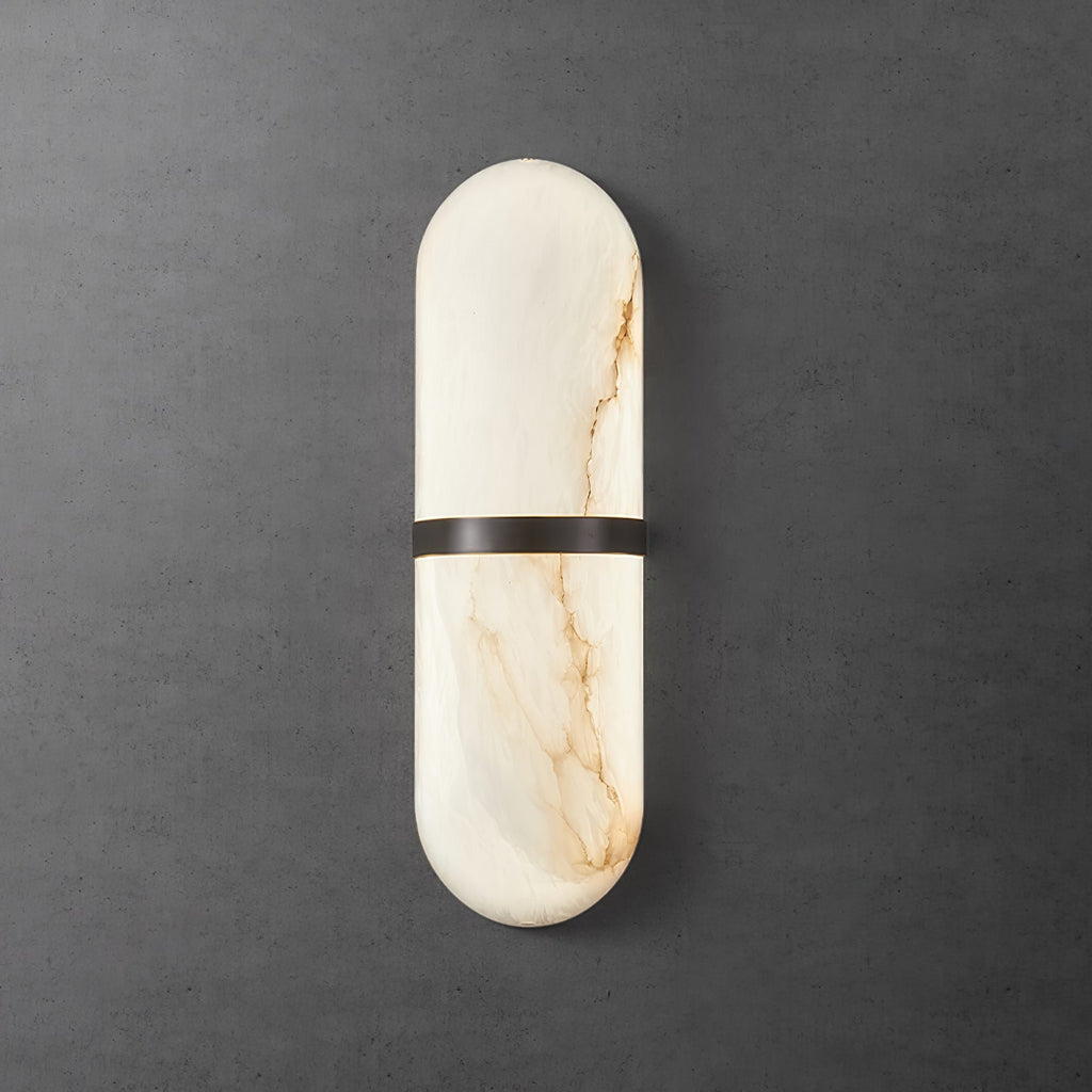 Clérachic bronze-banded alabaster wall lamp glowing softly against a dark textured concrete wall