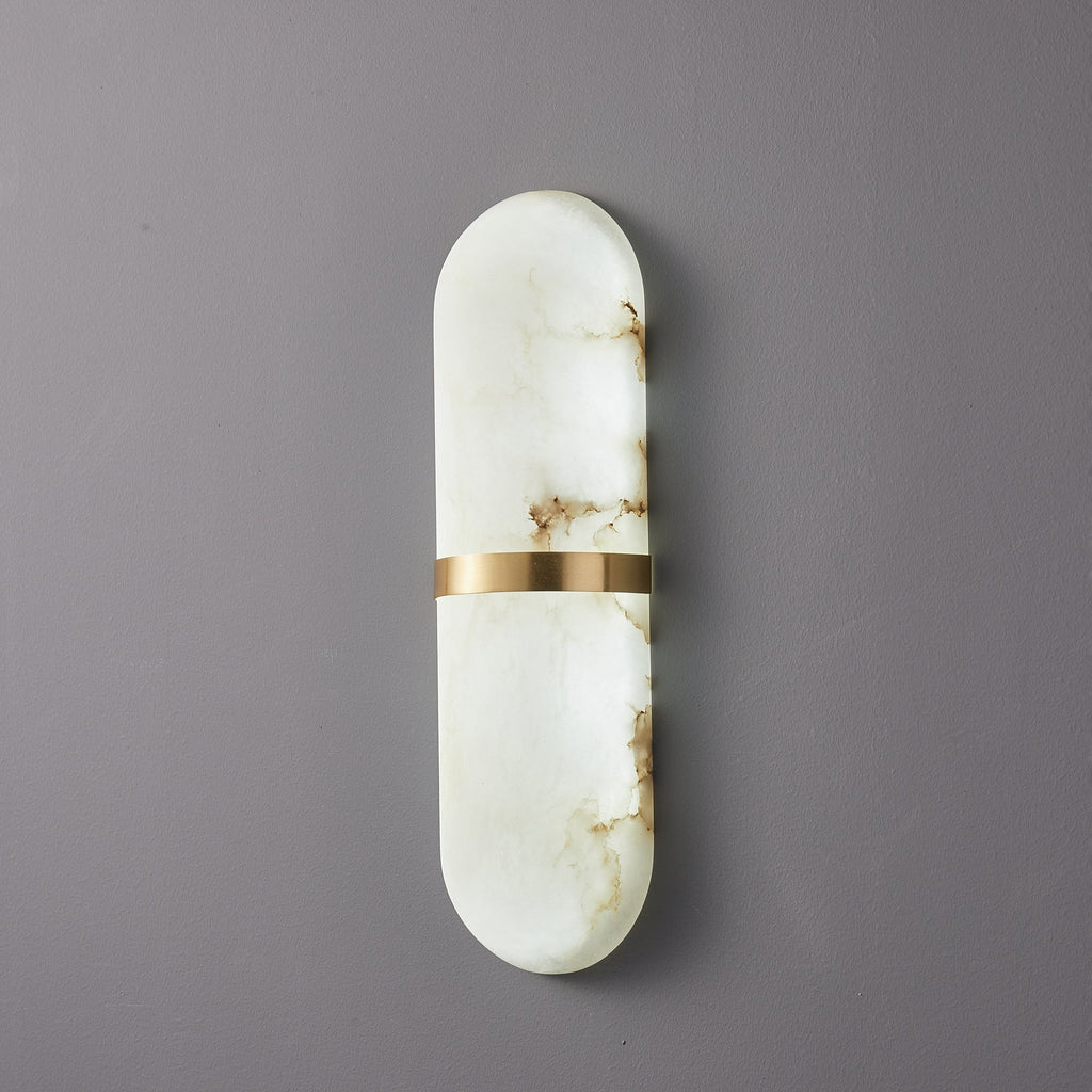 Clérachic three-quarter view of the unlit brass-banded alabaster lamp, showing the shade's rounded depth