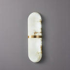 Clérachic three-quarter view of the unlit brass-banded alabaster lamp, showing the shade's rounded depth